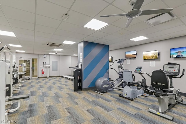 exercise room with carpet floors, ceiling fan, and a paneled ceiling