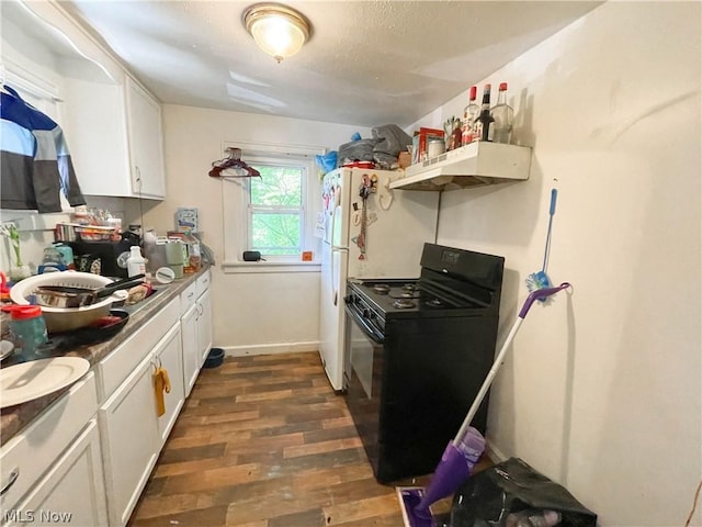 kitchen featuring black gas range, dark hardwood / wood-style flooring, and white cabinets