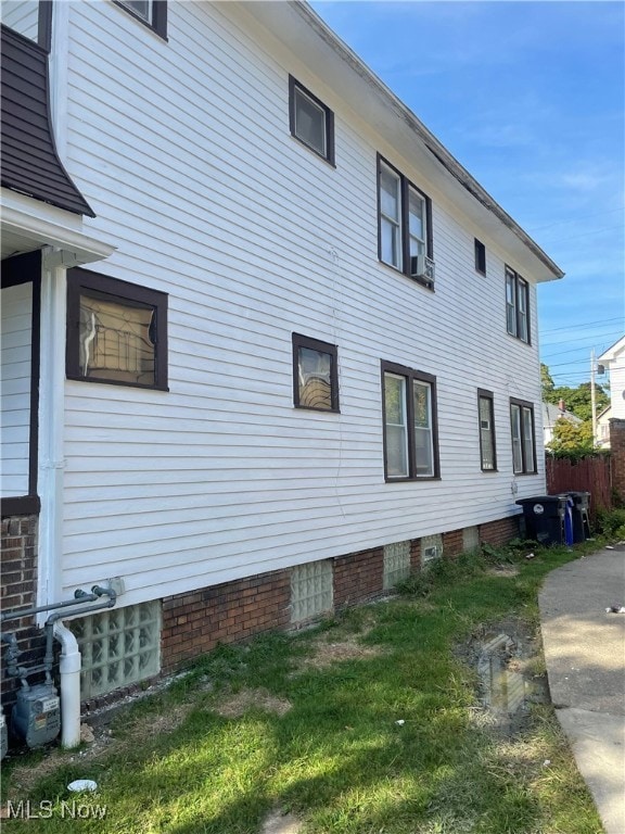 view of side of property with a lawn