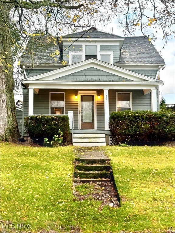 view of front of property with a front yard and covered porch