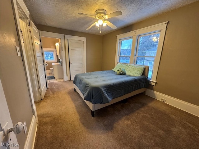 carpeted bedroom featuring multiple windows, ceiling fan, and a textured ceiling