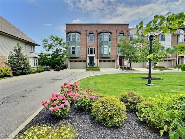 view of front of property with a garage and a front lawn