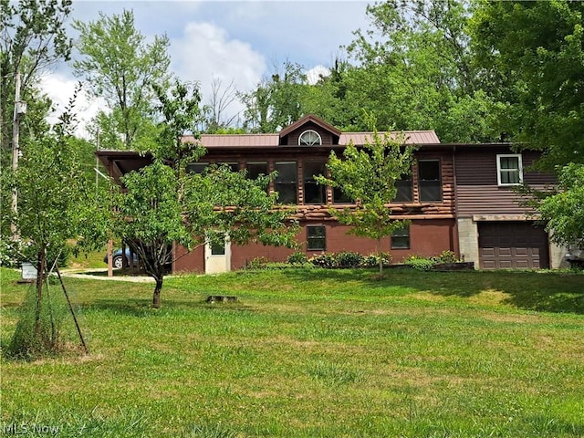 view of front of home with a garage, a front yard, and metal roof