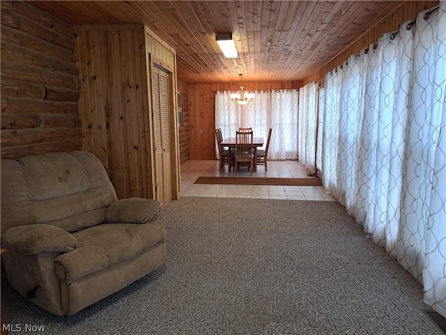 sitting room featuring wooden ceiling, light carpet, wood walls, and light tile patterned floors