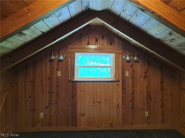 bonus room with lofted ceiling, wooden ceiling, and wood walls