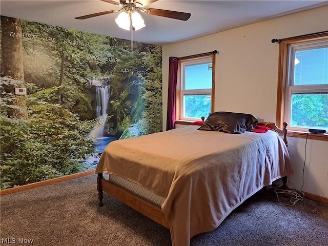 carpeted bedroom featuring ceiling fan and baseboards