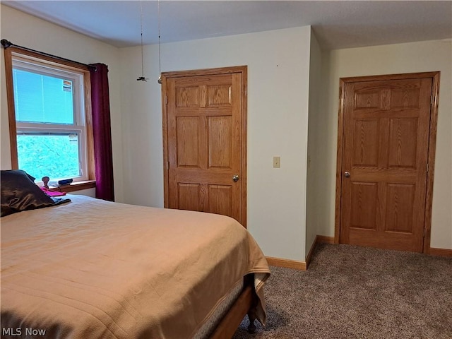 carpeted bedroom with baseboards