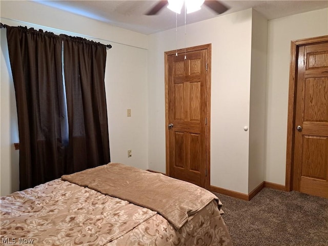 carpeted bedroom featuring a ceiling fan and baseboards