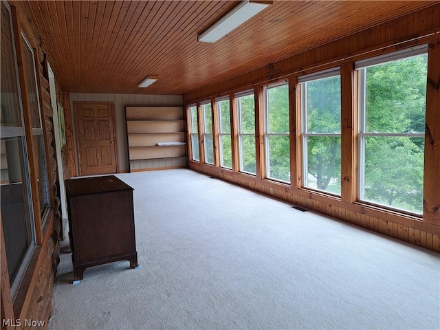 unfurnished sunroom featuring wooden ceiling