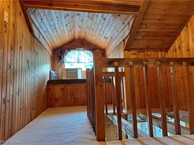 hall with wooden ceiling, cooling unit, light colored carpet, wooden walls, and vaulted ceiling