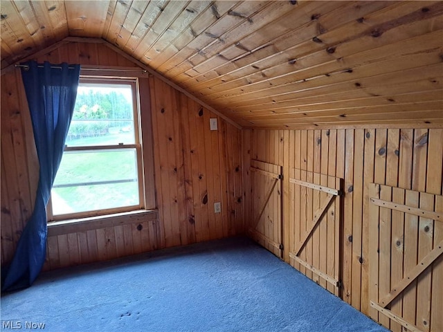 bonus room featuring lofted ceiling, wood walls, wooden ceiling, and carpet flooring