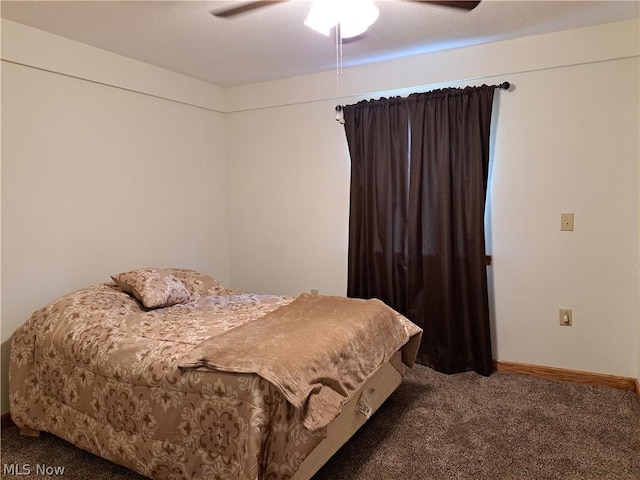 carpeted bedroom featuring a ceiling fan and baseboards