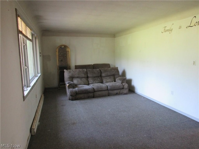 living room with dark colored carpet and baseboard heating