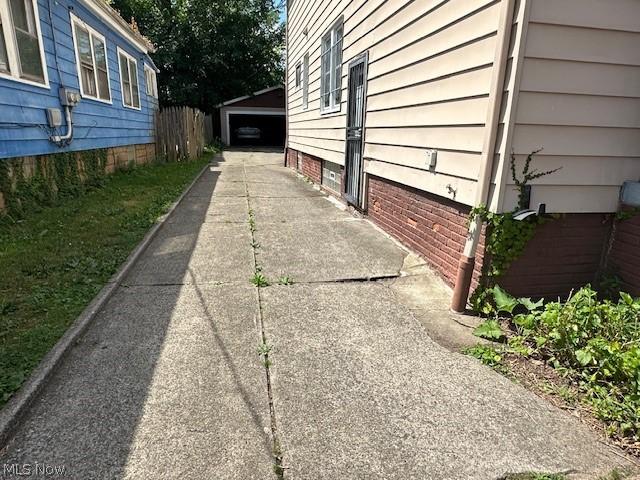 view of side of property with a garage and fence