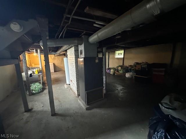 basement featuring heating unit and water heater