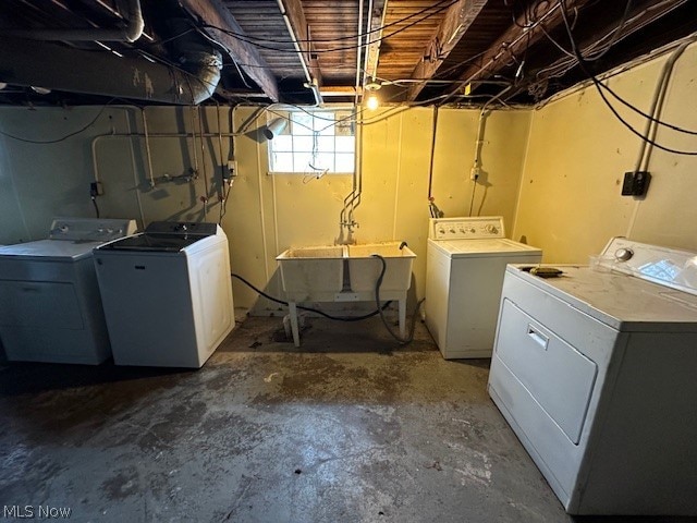 washroom featuring laundry area, independent washer and dryer, and a sink