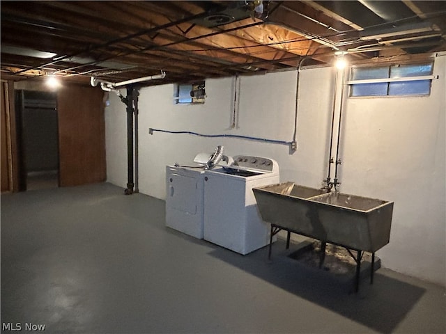 basement with separate washer and dryer and sink