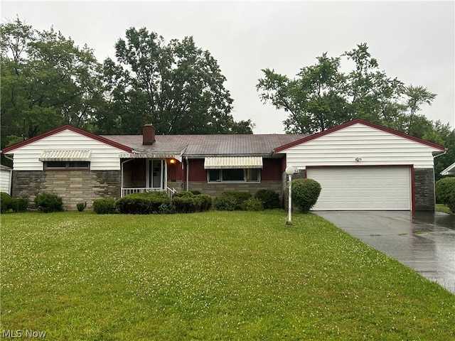 ranch-style home featuring a garage and a front lawn