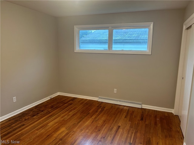 interior space featuring wood-type flooring and baseboard heating