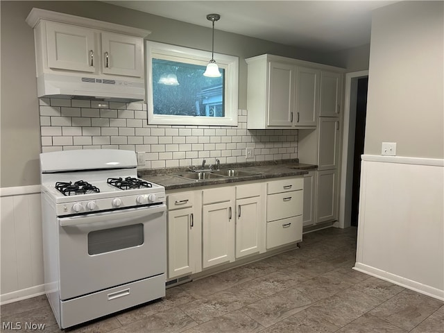 kitchen featuring custom range hood, tasteful backsplash, white gas range, white cabinets, and sink