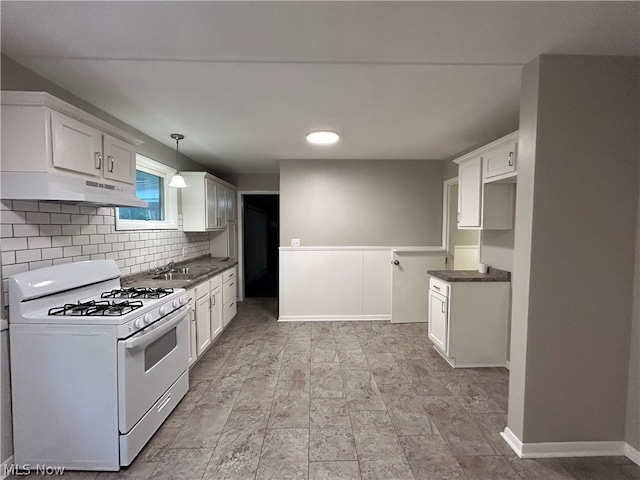 kitchen featuring white gas stove, premium range hood, light tile patterned floors, and white cabinets