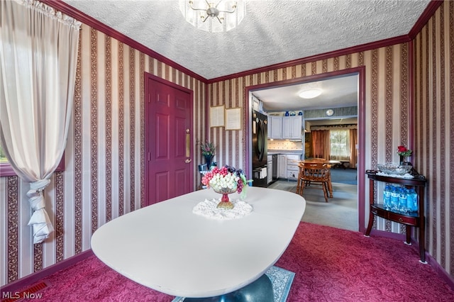 dining space featuring carpet floors, a textured ceiling, and crown molding