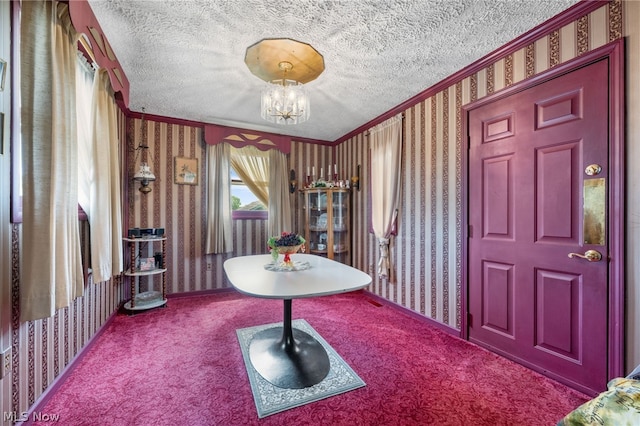 interior space featuring a textured ceiling, crown molding, and a chandelier