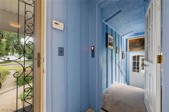 hallway with lofted ceiling