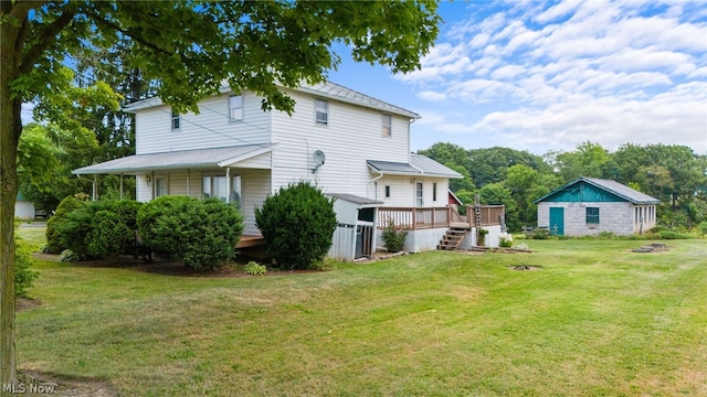 back of house featuring a yard and a deck