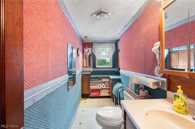 bathroom featuring ornamental molding, toilet, vanity, and tile patterned flooring