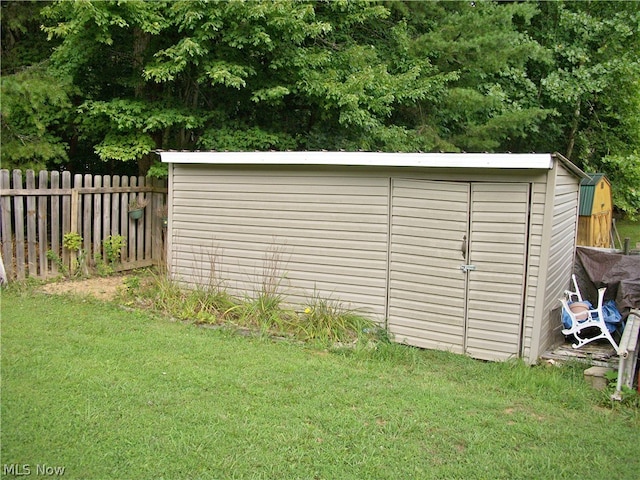 view of outdoor structure featuring a lawn