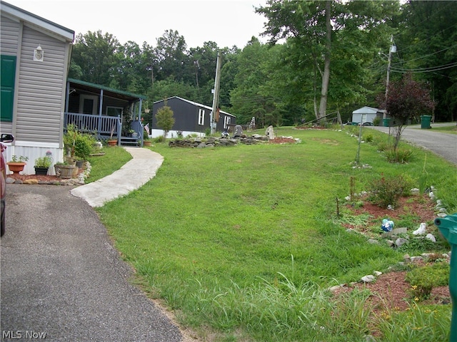 view of yard featuring covered porch