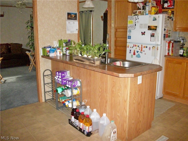 kitchen with sink and white fridge