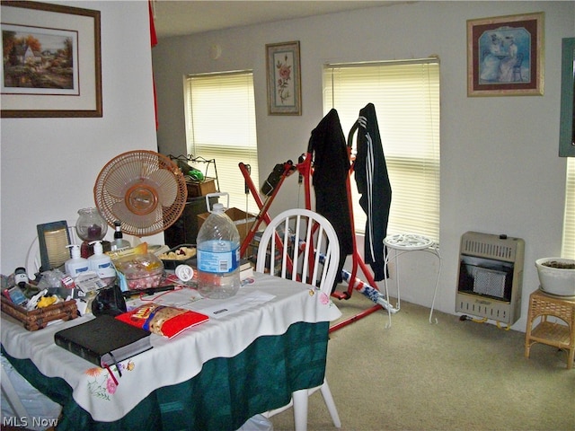 carpeted dining area with heating unit