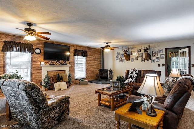 living room with carpet floors, plenty of natural light, and wood walls