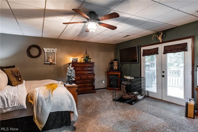 carpeted bedroom featuring ceiling fan, access to exterior, a paneled ceiling, and french doors