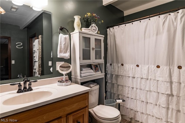 bathroom featuring vanity, toilet, and a shower with shower curtain