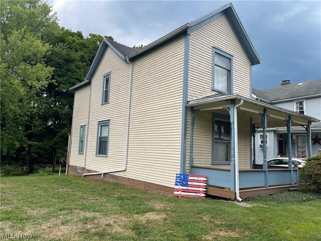 view of property exterior with a yard