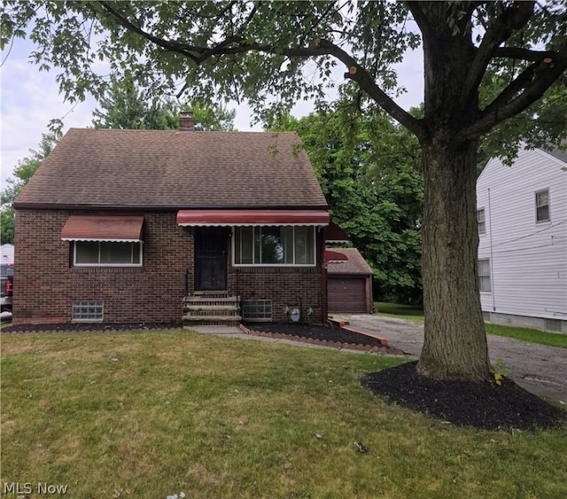 view of front of home with a garage and a front yard