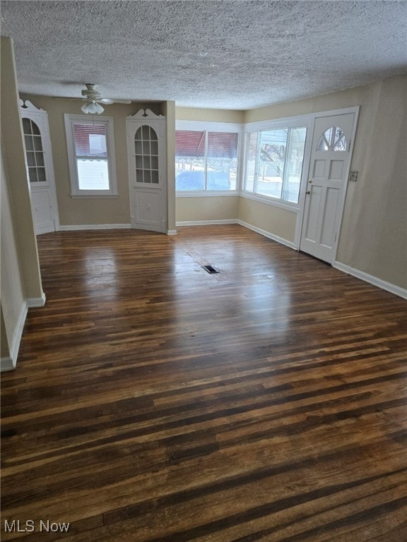 foyer featuring a textured ceiling, ceiling fan, and dark hardwood / wood-style floors