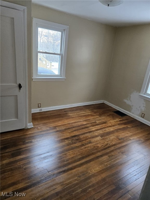 empty room with dark hardwood / wood-style floors