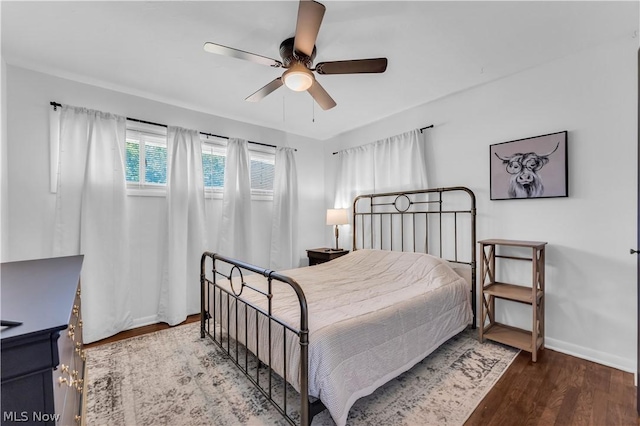 bedroom with ceiling fan and wood-type flooring