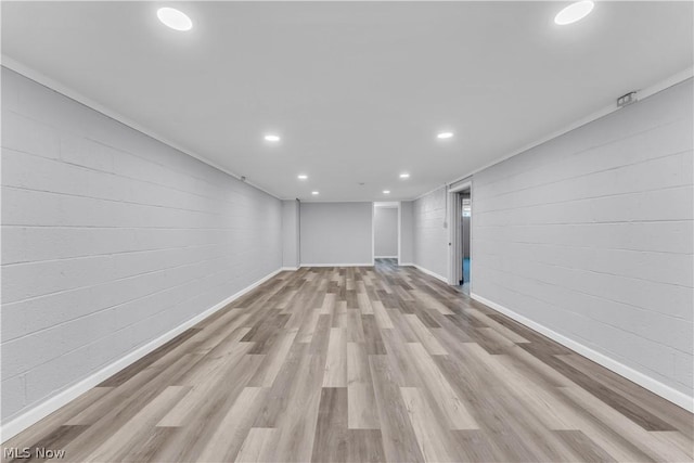 interior space with light wood-type flooring and ornamental molding