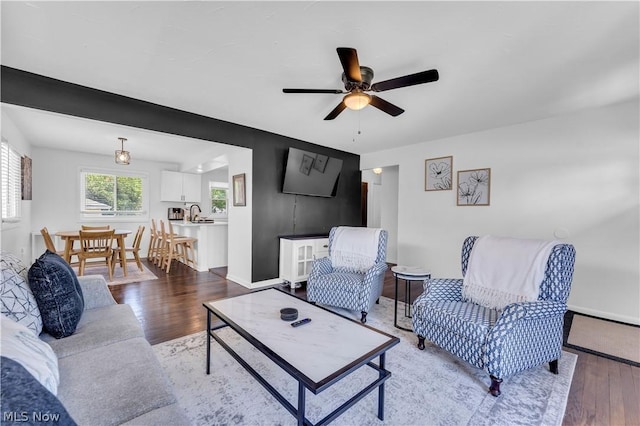 living room with sink, ceiling fan, and hardwood / wood-style floors