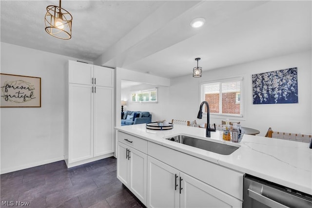 kitchen with pendant lighting, white cabinets, dishwasher, sink, and light stone counters