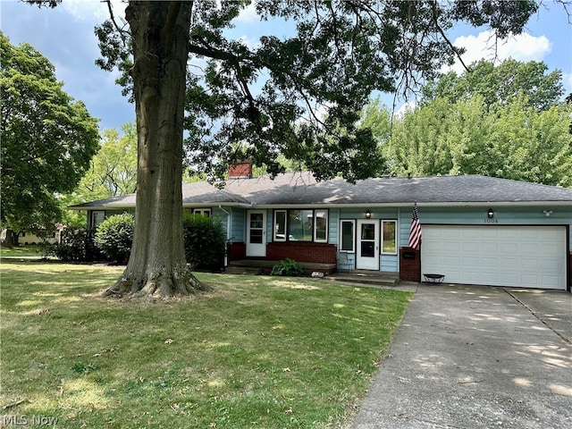 single story home featuring a garage and a front yard