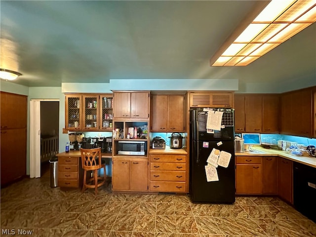 kitchen with tile patterned floors and black appliances