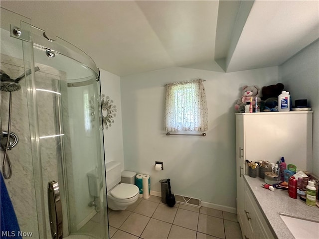 bathroom with a shower with shower door, tile patterned floors, vanity, and toilet