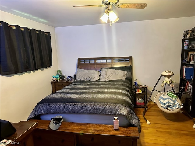 bedroom featuring hardwood / wood-style flooring and ceiling fan