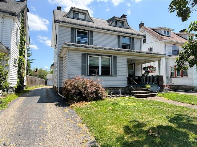 view of property with a front lawn and covered porch